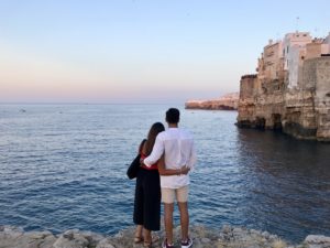 couple standing beside the sea